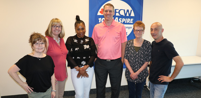 6 members of the Swiss Chalet negotiations committee pose for a group photo during a bargaining session at the union office. 